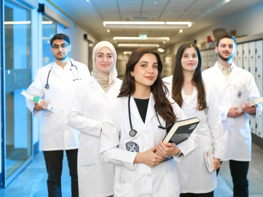 Group of medical students in white coats with stethoscopes